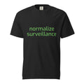 Black graphic t shirt with "normalize surveillance" on it in green letters. This is a meme shirt designed to be anti flock camera, and mock modern technology. 